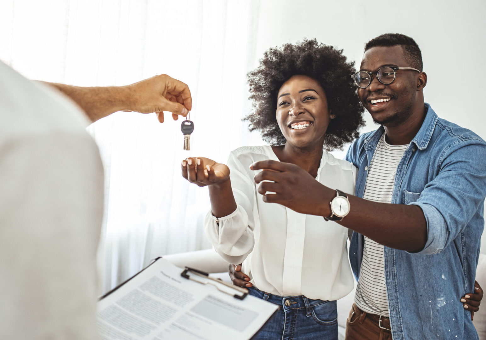 Happy couple receiving new home keys